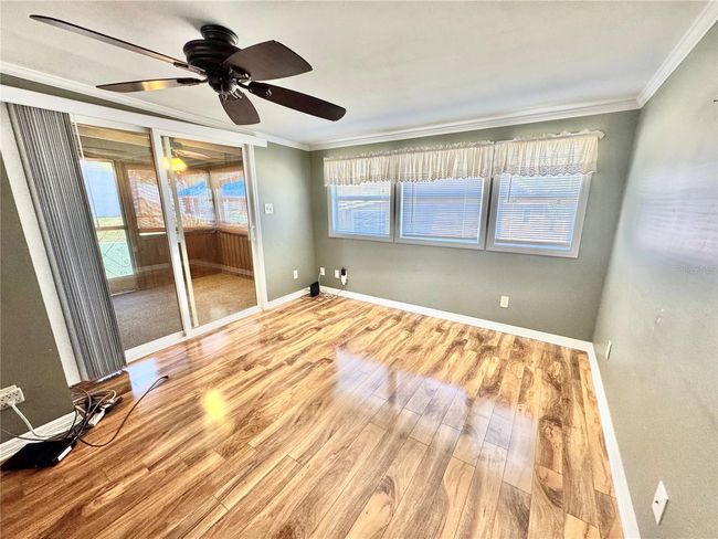 View of living room to rear screened in porch | Image 7