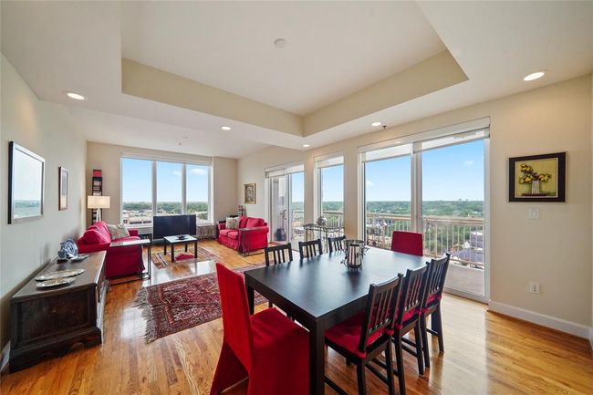 Spacious open-concept dining and living area with expansive windows offering stunning views. | Image 12