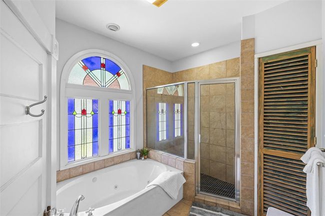 Pamper yourself in this well appointed bath with beautiful glass work. | Image 5