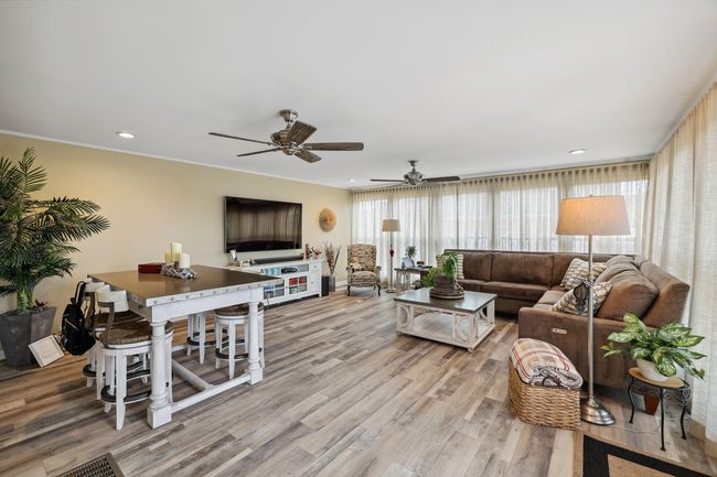 Always a favorite spot, the large Florida Room offers an additional recreation area on the main level and tons of natural light. | Image 14