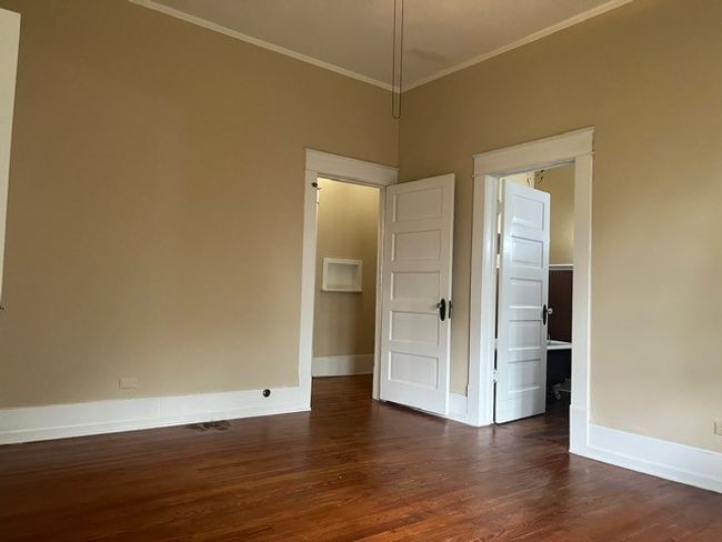 Spare room with dark wood finished floors and crown molding | Image 18