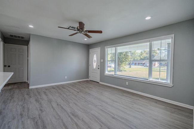 Spacious living room filled with natural light. Open layout allows for flexible furniture arrangements, perfect for creating a cozy seating area or a combined living and dining space | Image 9