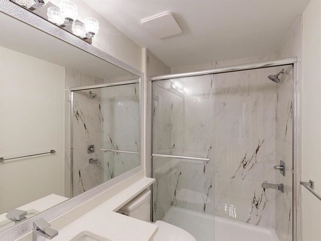Bathroom with a marble finish shower and vanity | Image 38