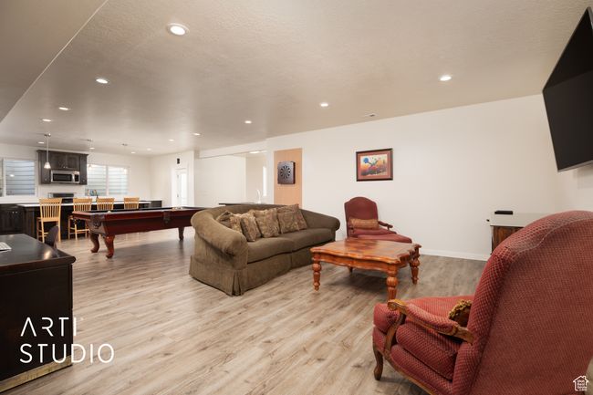 Living room featuring pool table, a textured ceiling, and light wood-type flooring | Image 29