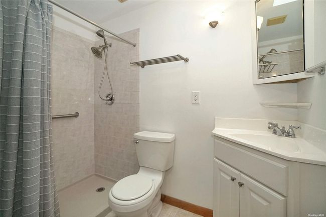 Hallway Bathroom with toilet, vanity, a tile shower | Image 15