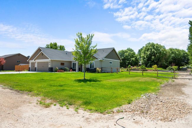 View of front of home with a garage, concrete driveway, and board and batten siding | Image 42