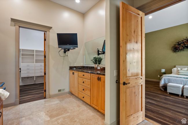 Master Full bathroom with vanity, baseboards, recessed lighting, wood finished floors, and ensuite bath | Image 39