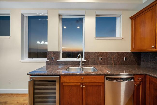 In this elegant kitchen enjoy the brand new a built in wine cooler and your sunset views through multiple windows. | Image 15