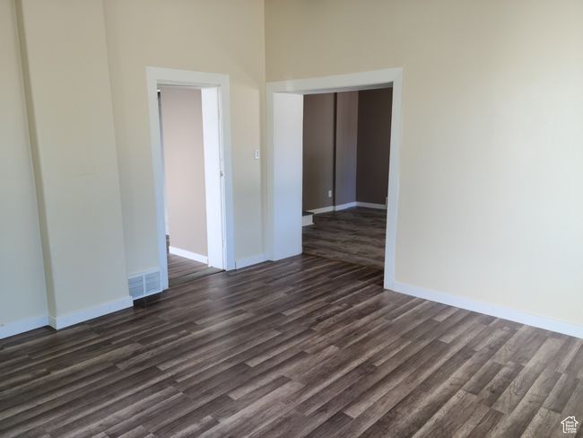 Spare room featuring dark wood-type flooring and baseboards | Image 19
