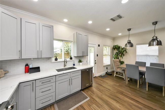 Enjoy an updated kitchen featuring elegant quartz countertops and stylish, modern cabinetry. | Image 11