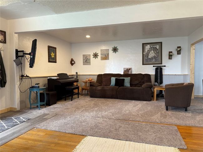 Living area featuring wood finished floors, wainscoting, and recessed lighting | Image 11