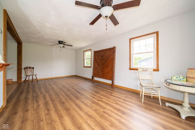 unfurnished room with ceiling fan, wood finished floors, and baseboards | Image 23
