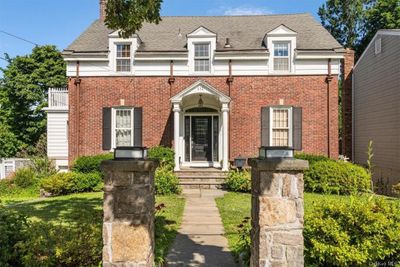 View of front of house with a front lawn and a balcony | Image 2