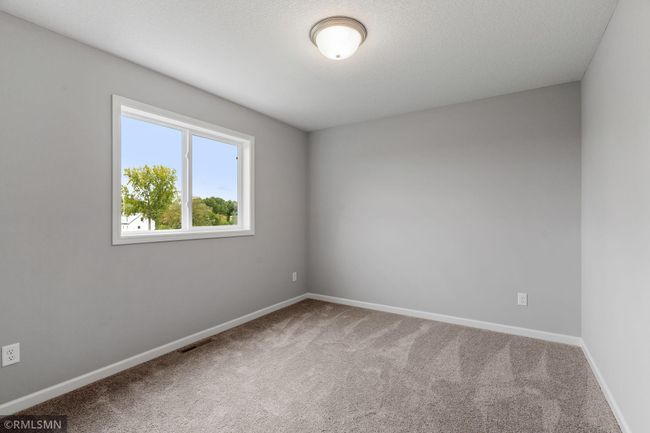 (Photo of previously finished home) One of three generously sized secondary bedrooms. | Image 15