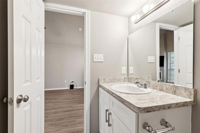 Bathroom featuring vanity, wood finished floors, and a textured ceiling | Image 10