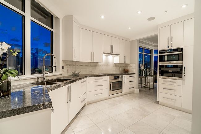 Kitchen with a sink, decorative backsplash, white cabinets, recessed lighting, and under cabinet range hood | Image 24