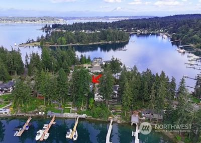 Deep-water docks are rare! The shared dock is on the north line and is shared with the neighbor to the north. Water and 110 power on the shore. Sellers have a sail boat and the neighbor has a 34 foot boat with a 3.5 ft draft. This home is perched on a peninsula that divides Honeymoon Bay from Echo Bay. These areas are known for protected deep-water moorage. | Image 3