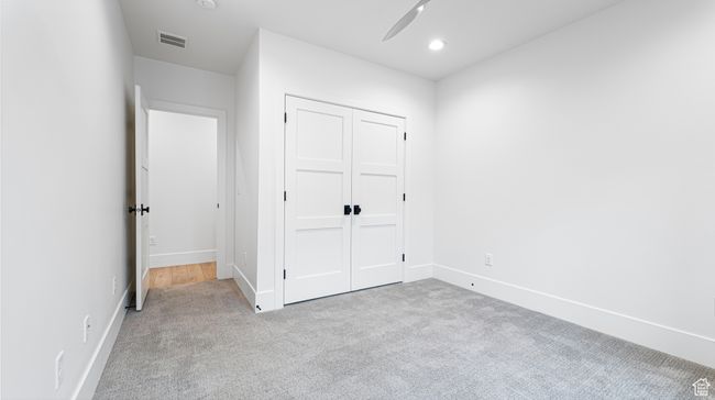 Unfurnished bedroom featuring a closet, visible vents, carpet flooring, and baseboards | Image 63