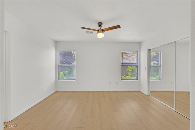 Unfurnished bedroom with light wood-style floors and a ceiling fan | Image 9