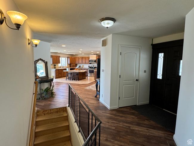 Entryway with recessed lighting, stairs, dark wood-style flooring, and baseboards | Image 19