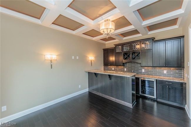 Bar with baseboards, backsplash, coffered ceiling, and wine cooler | Image 12