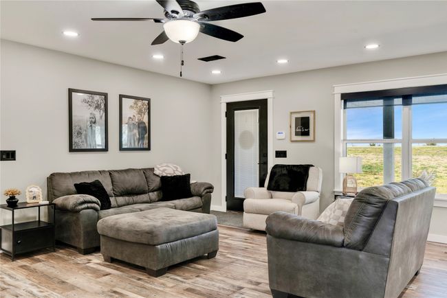 Living room with baseboards, ceiling fan, recessed lighting, and light wood finished floors | Image 6