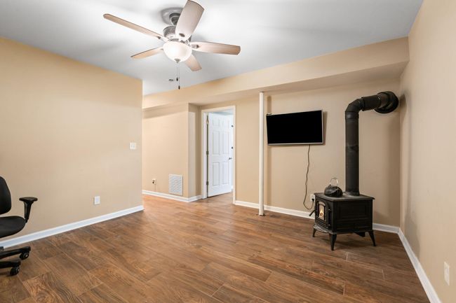 Wood burning stove and wall TV convey to buyer. | Image 34