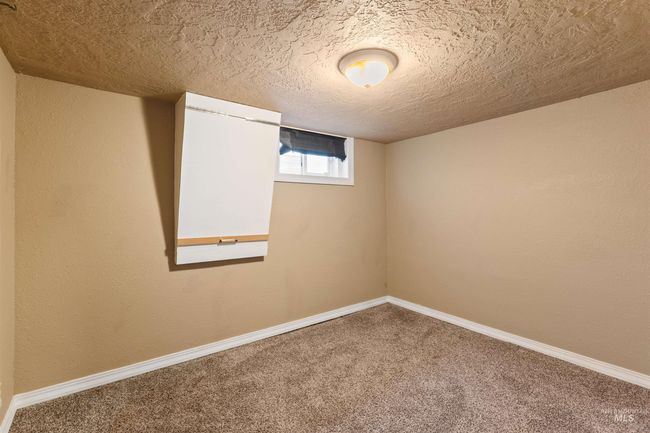 Spare room with a textured ceiling, carpet flooring, and a textured wall | Image 35