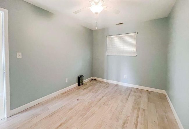 Empty room with baseboards, ceiling fan, and light wood finished floors | Image 21