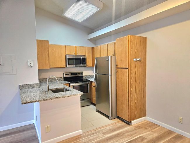 GRANITE COUNTER TOPS EXTENDED TO CREATE A SNACK BAR | Image 9
