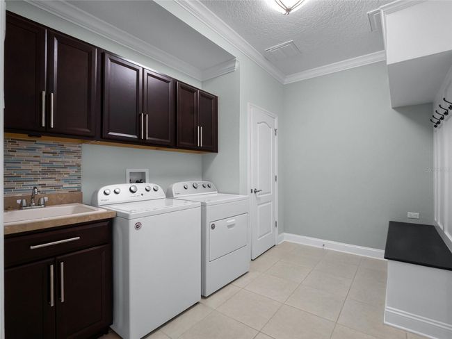 Washer and dryer stay, built in drop zone and large under stairs closet for storage | Image 49