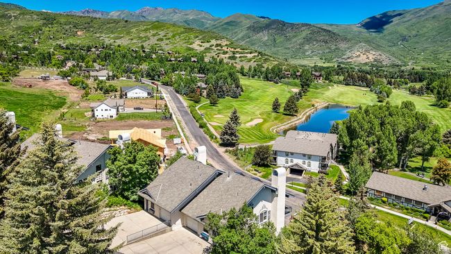 Aerial perspective of suburban area with a water and mountain view and a golf club | Image 26