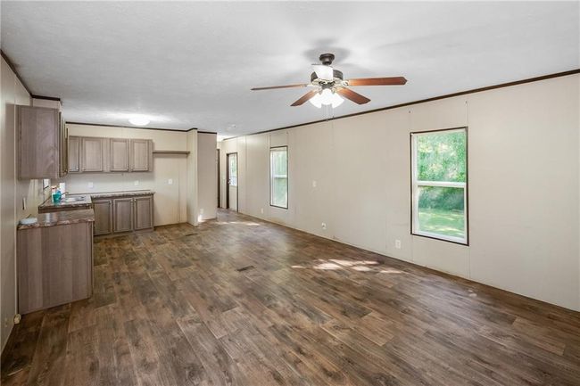 Kitchen featuring ceiling fan, dark wood-type flooring, and stone counters | Image 20