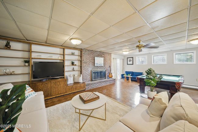 1st floor spacious living room with hw floors, fireplace, kitchenette nearby with sliders to level yard | Image 33