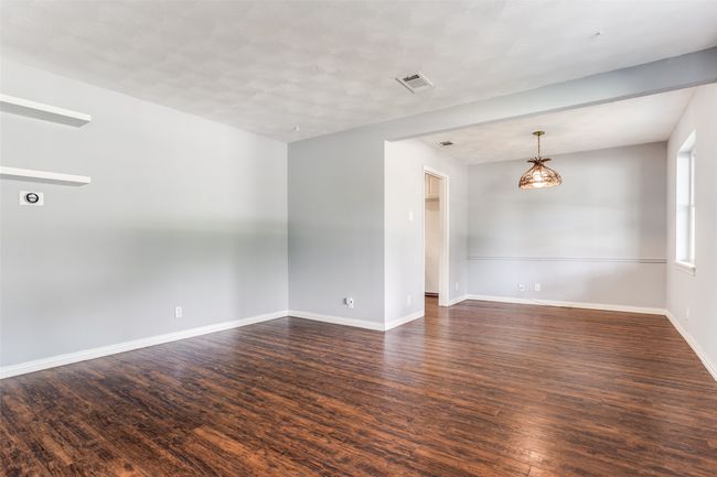 Empty room with dark wood-style floors and baseboards | Image 9