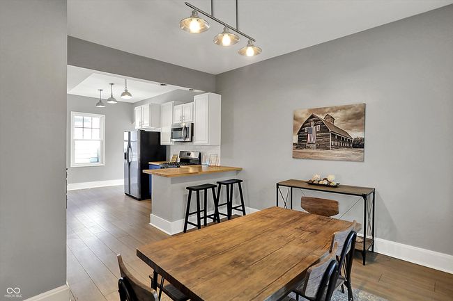 dining room featuring wood finished floors and baseboards | Image 12