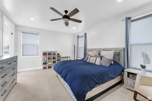 Primary suite bedroom with recessed lighting and a ceiling fan | Image 12