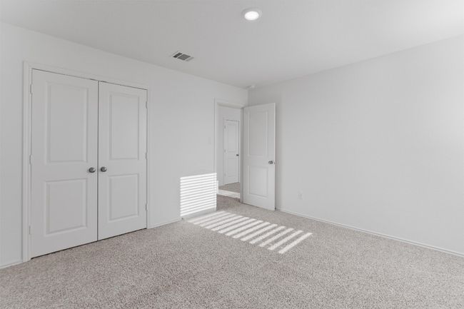Unfurnished bedroom featuring carpet floors, a closet, visible vents, and baseboards | Image 29
