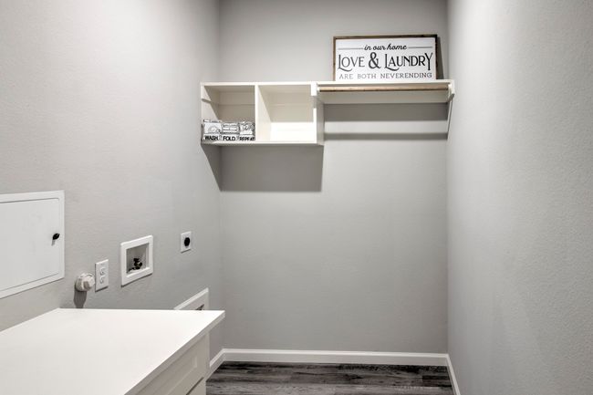 Washroom featuring electric dryer hookup, wood finished floors, and hookup for a washing machine | Image 18