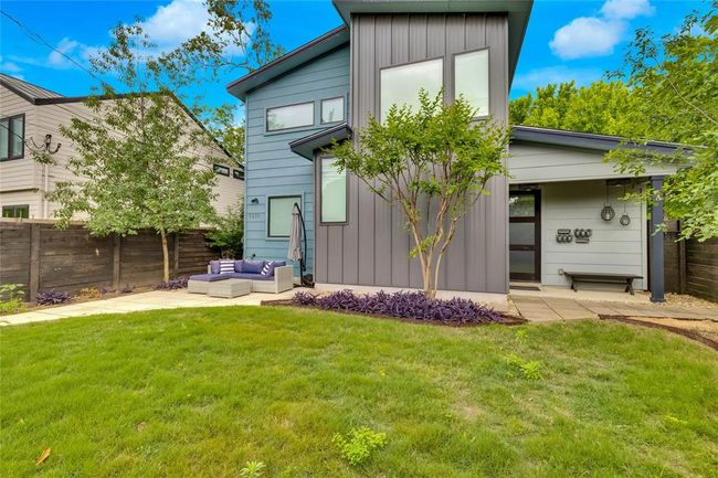 Rear view of property with outdoor lounge area, board and batten siding, and a patio area | Image 22