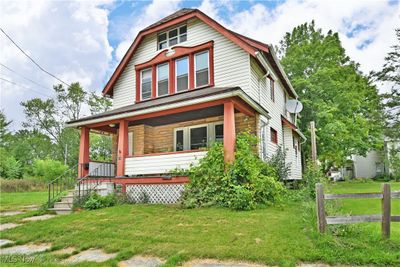 View of front of home with a front yard and a porch | Image 1