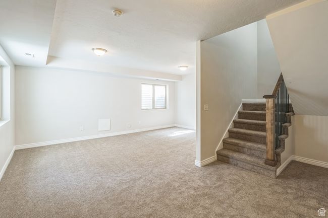 Basement with carpet flooring and stairway | Image 5