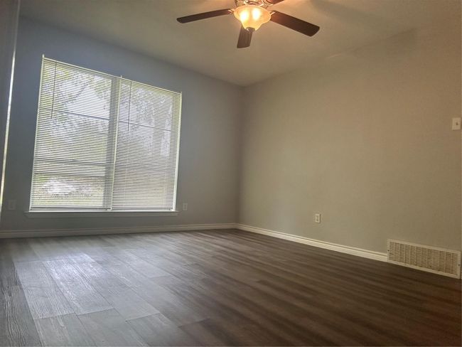 Empty room featuring baseboards, dark wood finished floors, and ceiling fan | Image 8