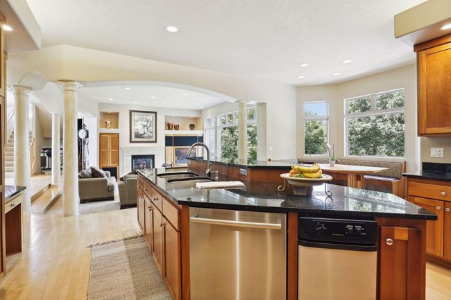 Granite countertop throughout the kitchen. Stainless steel appliances! High ceilings span the main level! | Image 11