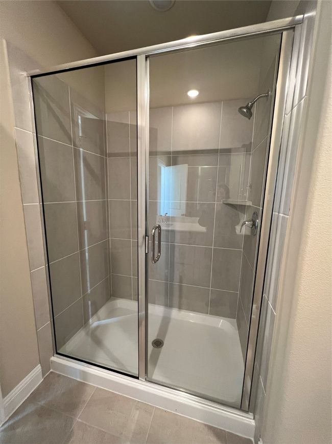 Bathroom featuring a stall shower and tile patterned floors | Image 6