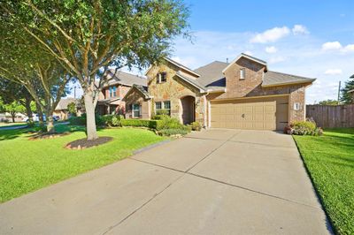 2-car garage with a long driveway. | Image 2