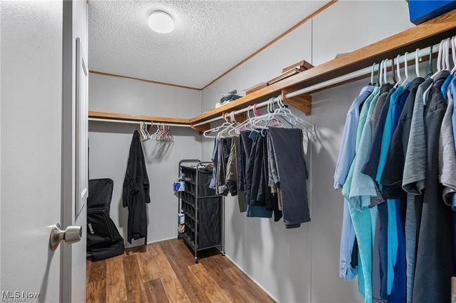 Walk in closet with wood finished floors | Image 14