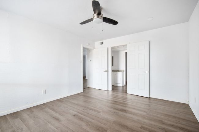 Unfurnished bedroom featuring ceiling fan and hardwood / wood-style flooring | Image 14