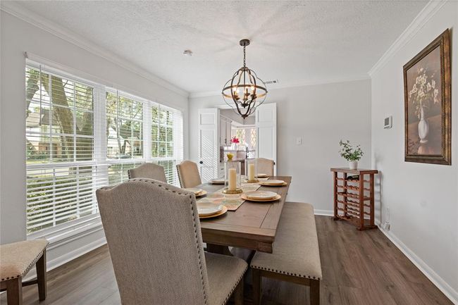 Spacious formal dining room with view of front of home. Nice and bright with access to the kitchen. | Image 8