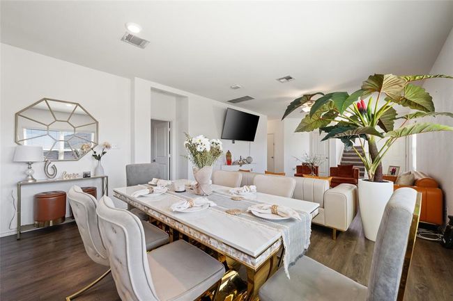 Dining space with wood finished floors and stairway | Image 12